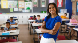 Portrait of african american female teacher smiling in the class at school. school and education concept
